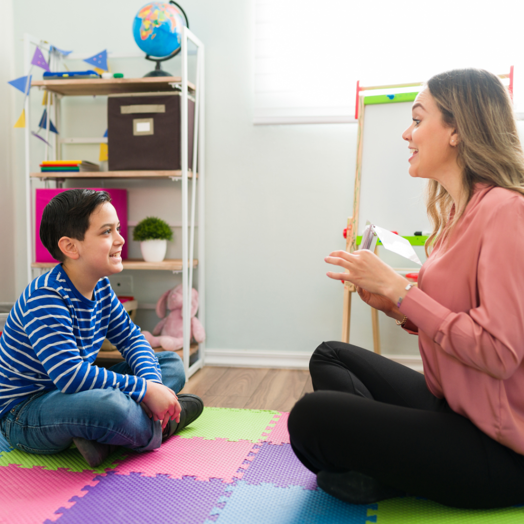 boy working with woman using flashcards